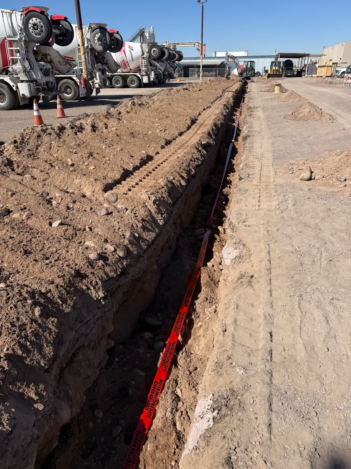 Conduit trench along an active work area