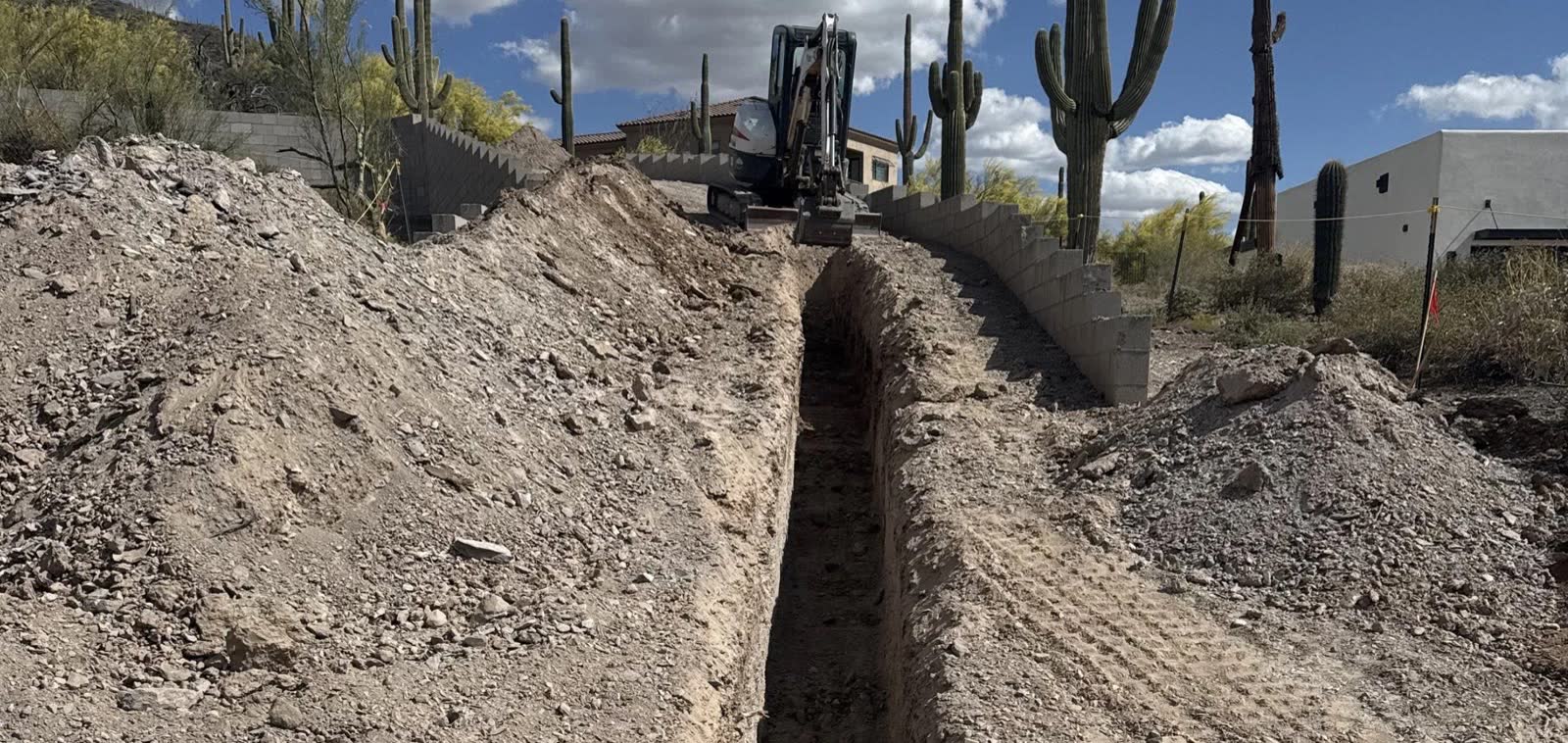 Excavated trench cut through a desert residential site