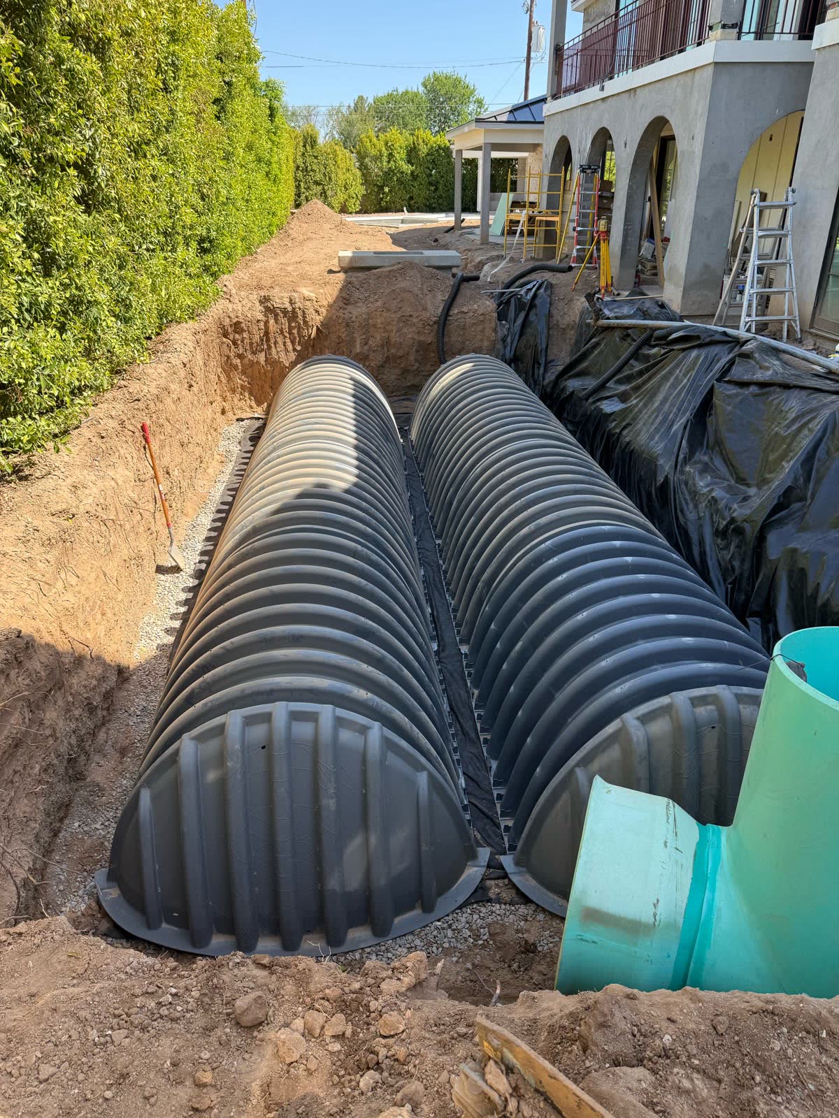 Corrugated septic chambers set in a prepared trench