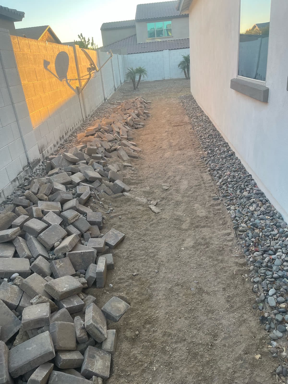 Side yard dirt path prepared for pavers