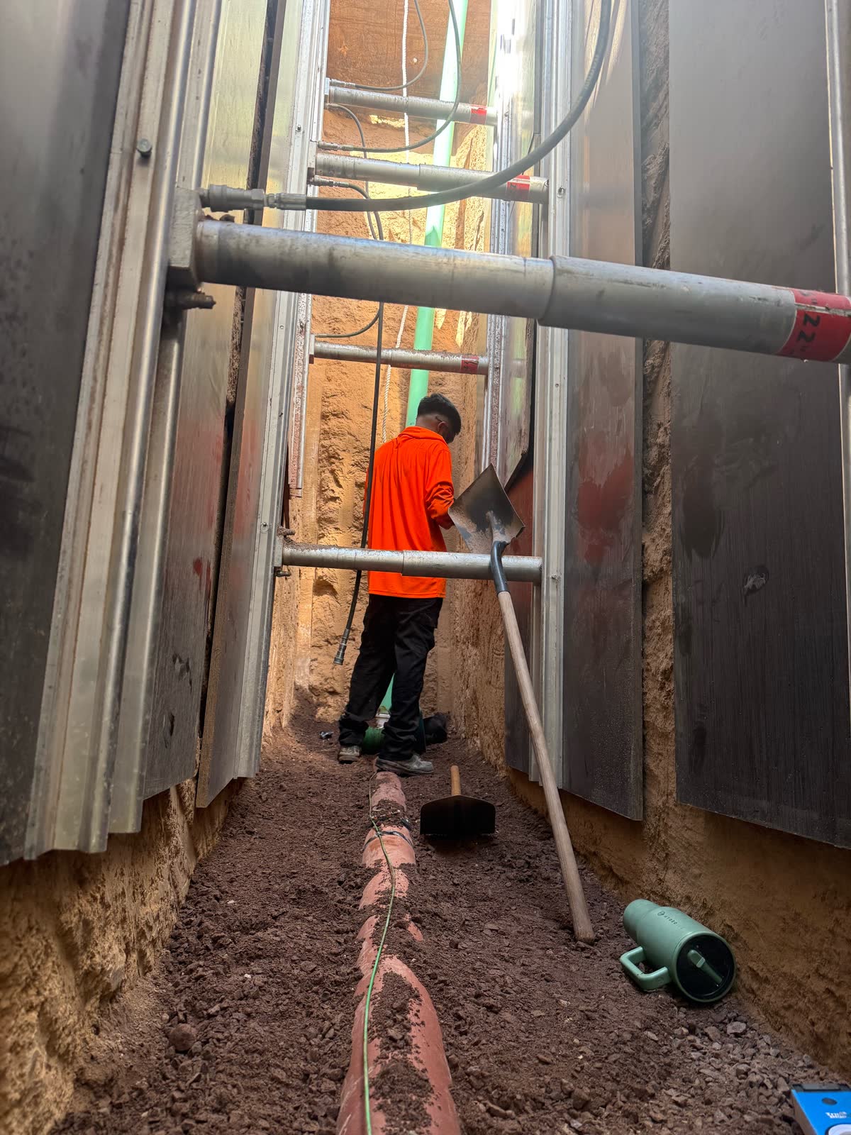 Deep shored utility trench with tracer wire and crew