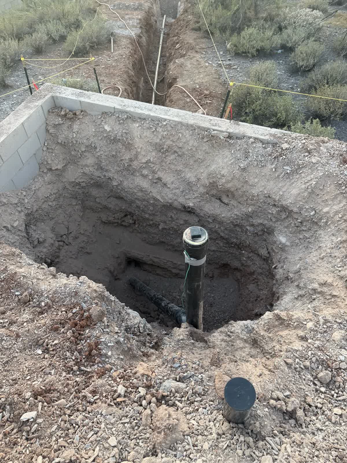 Water service riser and pipe in an open trench
