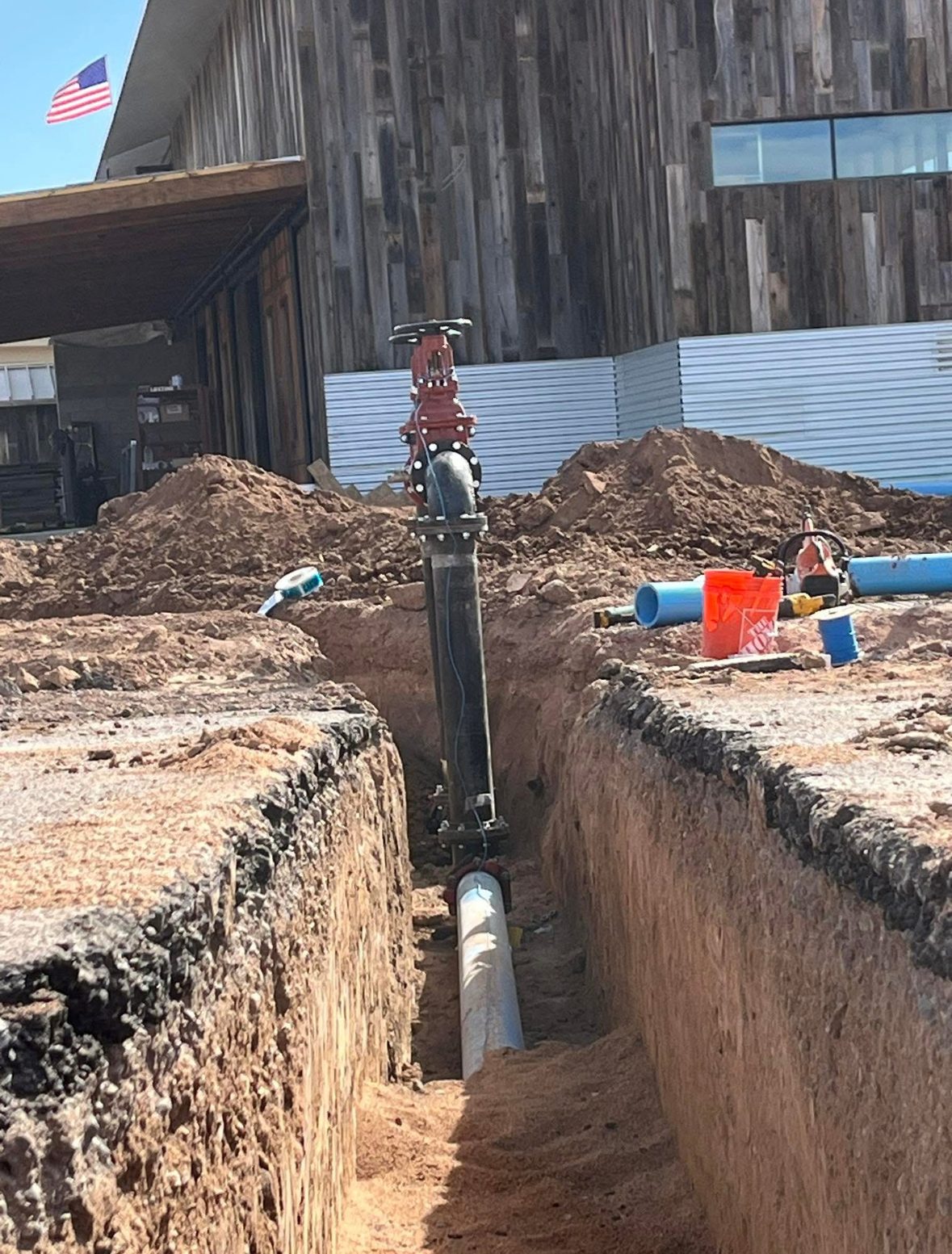 Water valve riser and pipe in utility trench